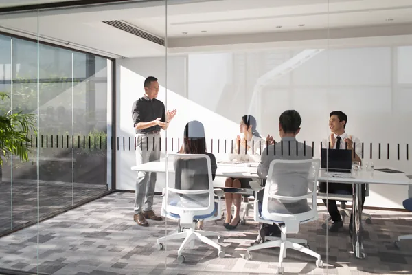 A meeting in a conference room, an illustrative collaboration scene
