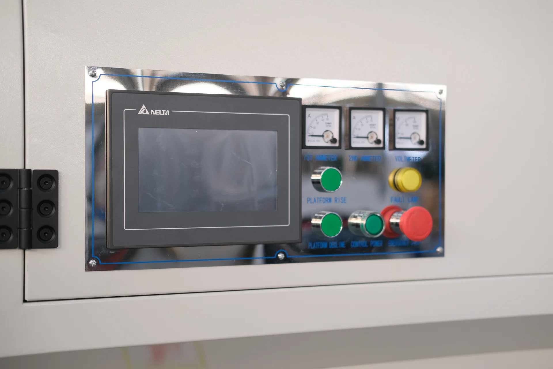 Deburring-machine operator panel with a Delta HMI, analog meters, pushbuttons and an emergency stop.