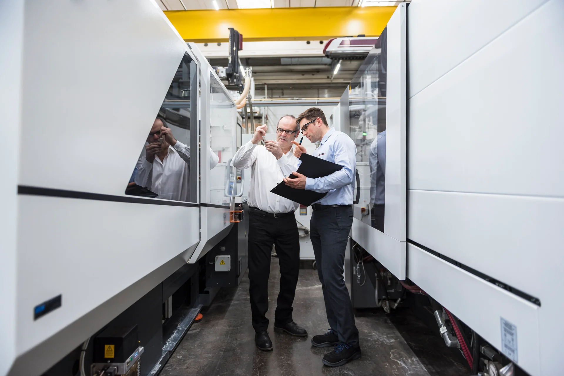 Engineers at a machining installation; illustration