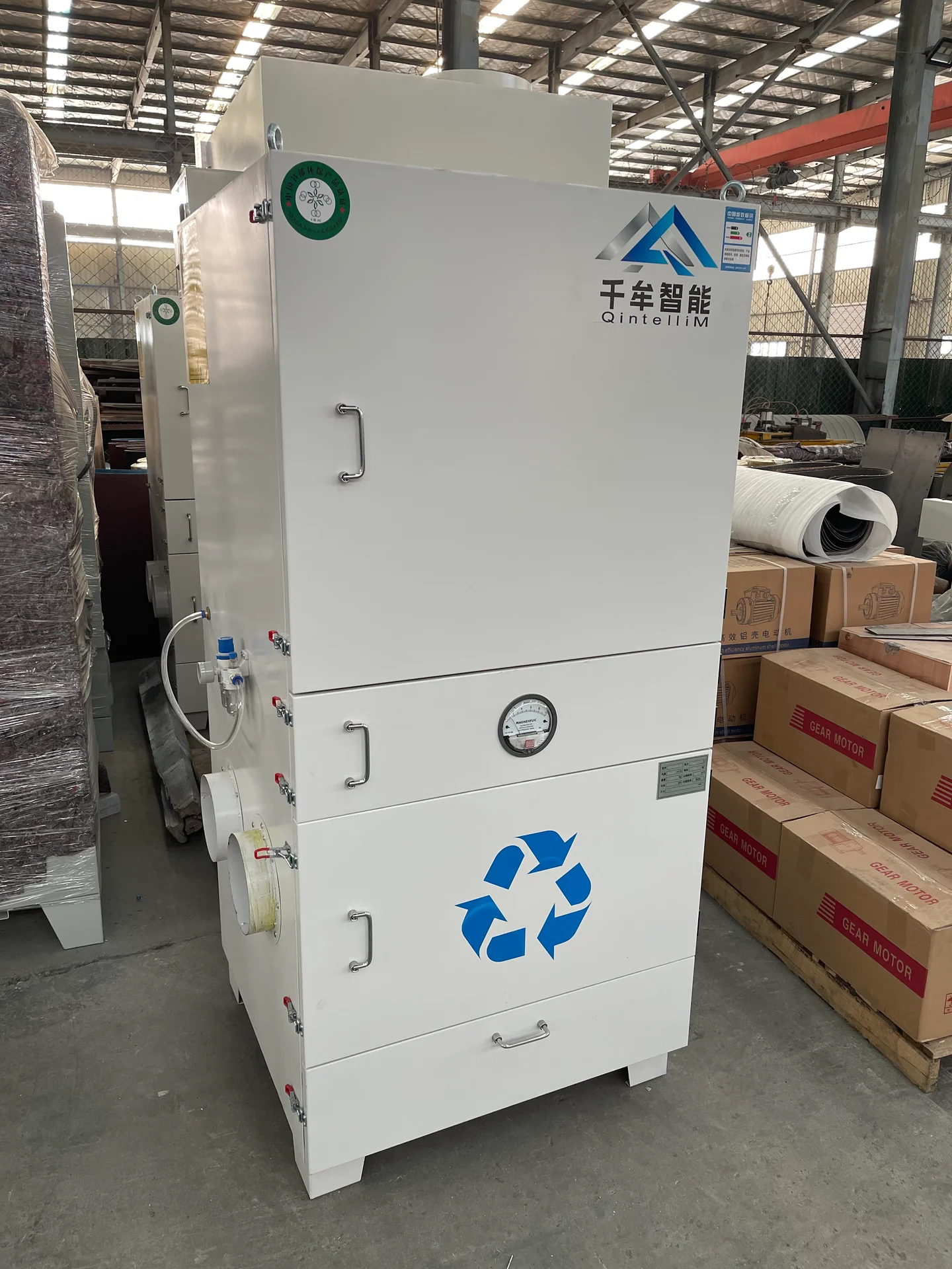 Freestanding dust extraction cabinet with a front pressure gauge, access panel and lower collection drawer.