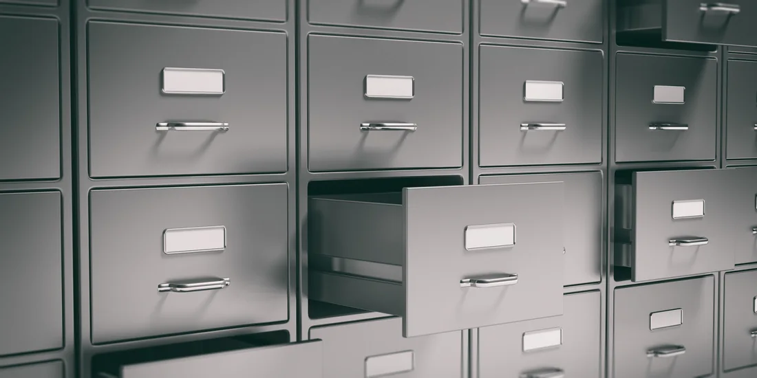 Metal filing cabinets with open drawers