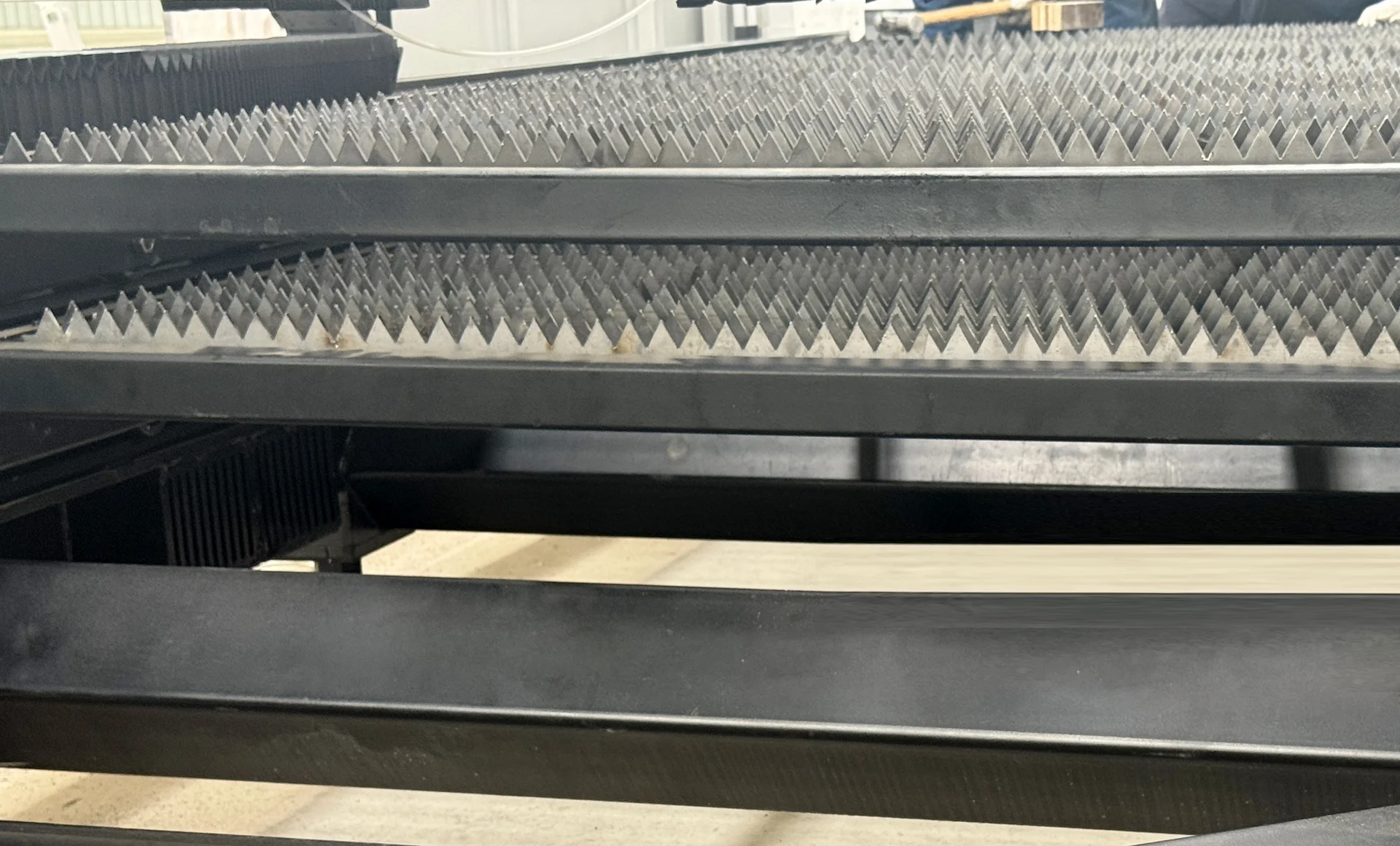 Two stacked slatted cutting platforms within a laser machine exchange-table structure