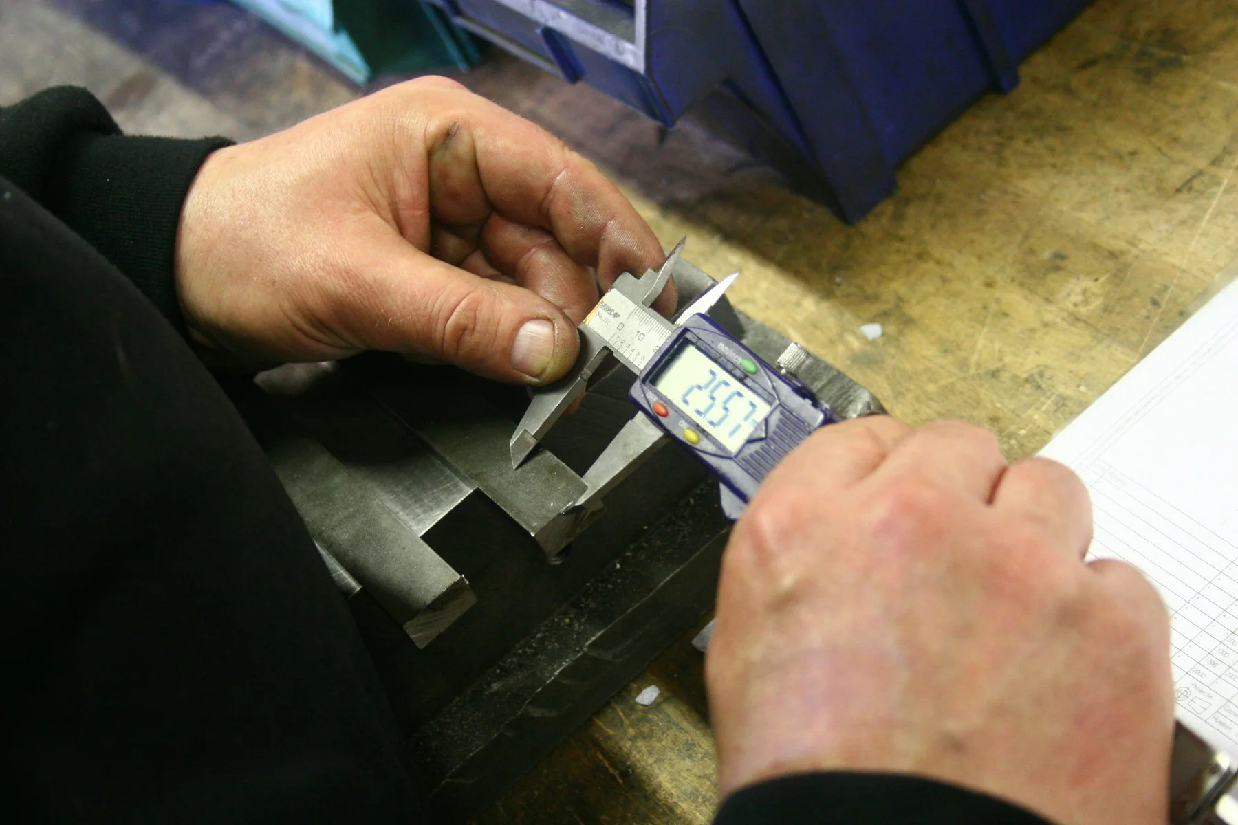 Measuring an industrial component with a digital caliper; reference