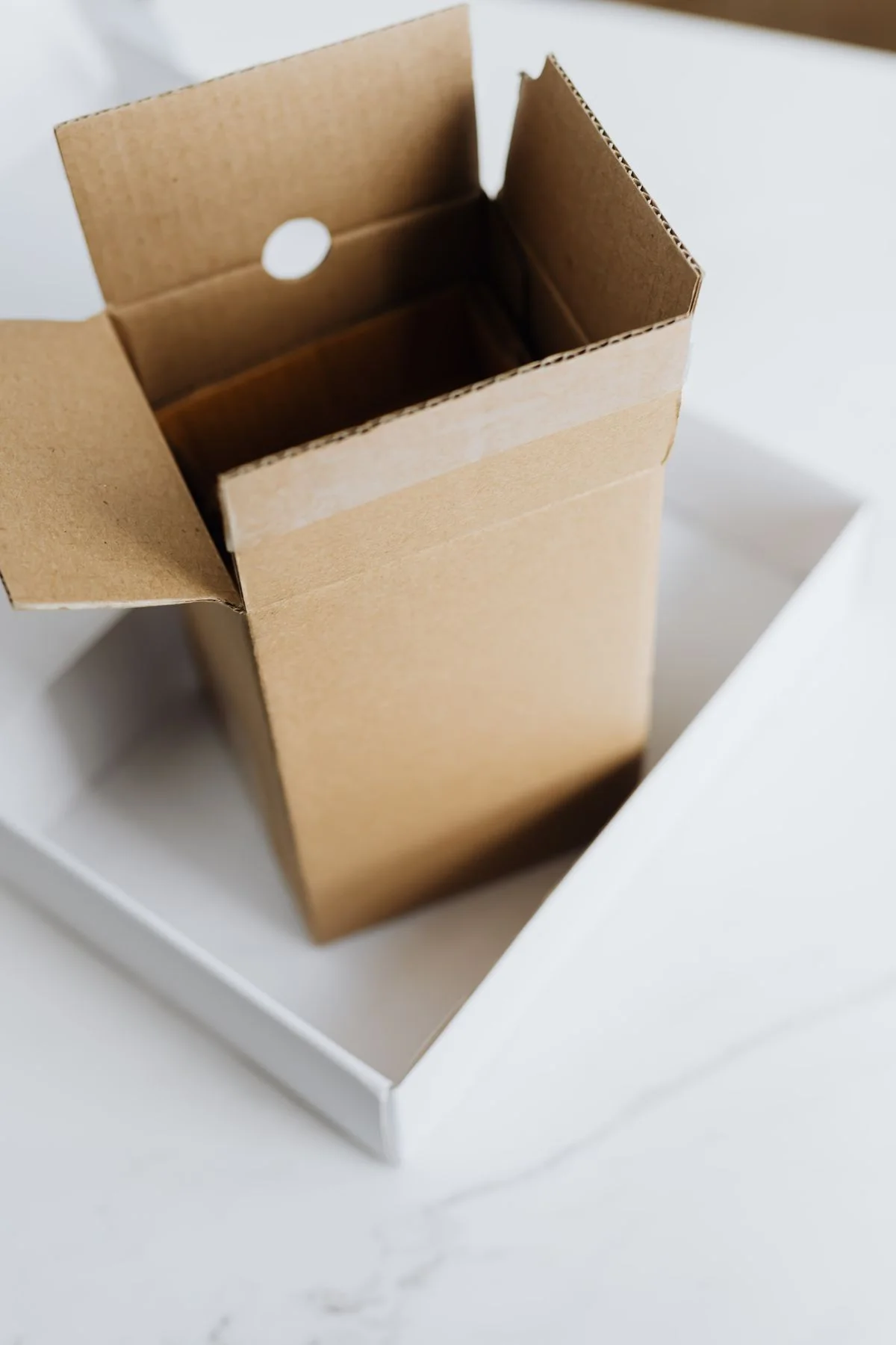 Open brown and white folded cardboard structures; packaging illustration