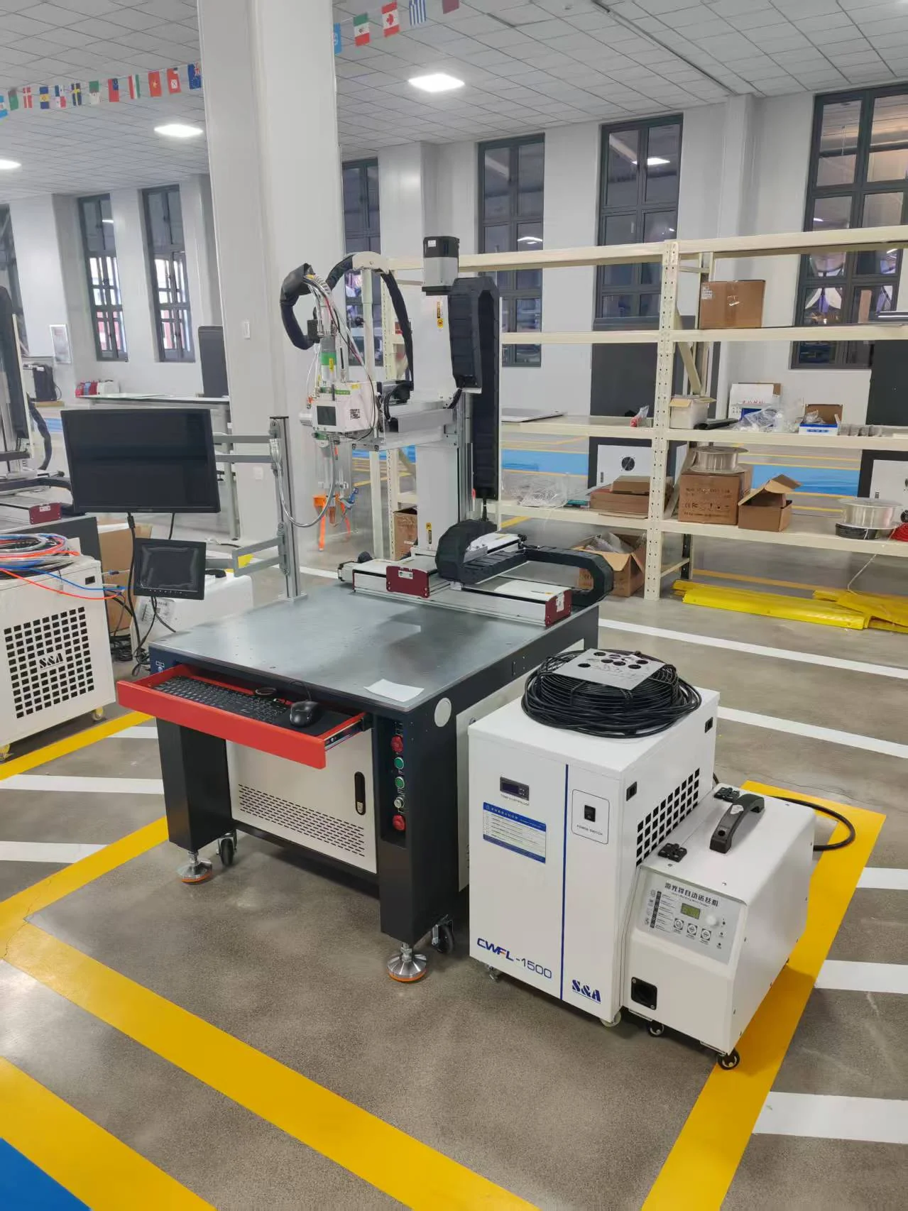 Automatic laser welding workstation with a positioning table, welding head, monitor and external chiller.