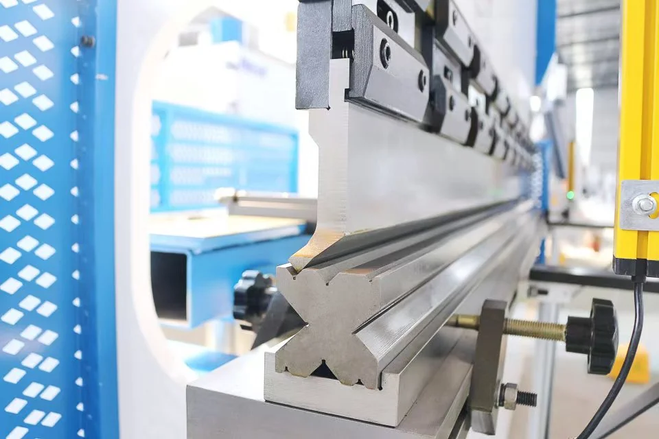 Close-up of a press brake punch aligned with a multi-V lower die.