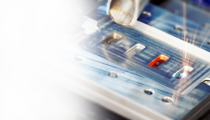 Laser welding electrical contacts held in a machined fixture