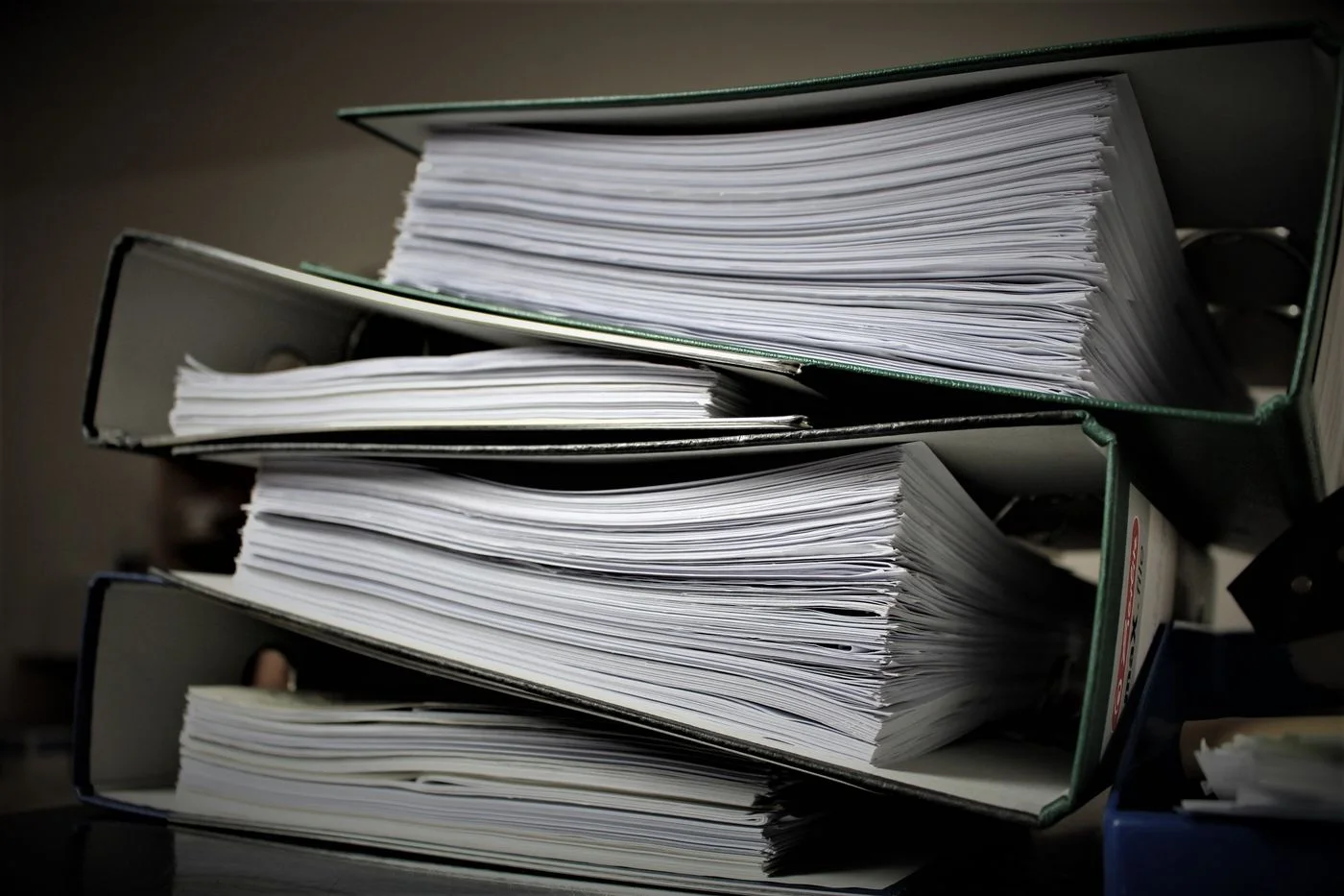 Stacked office document binders; records illustration