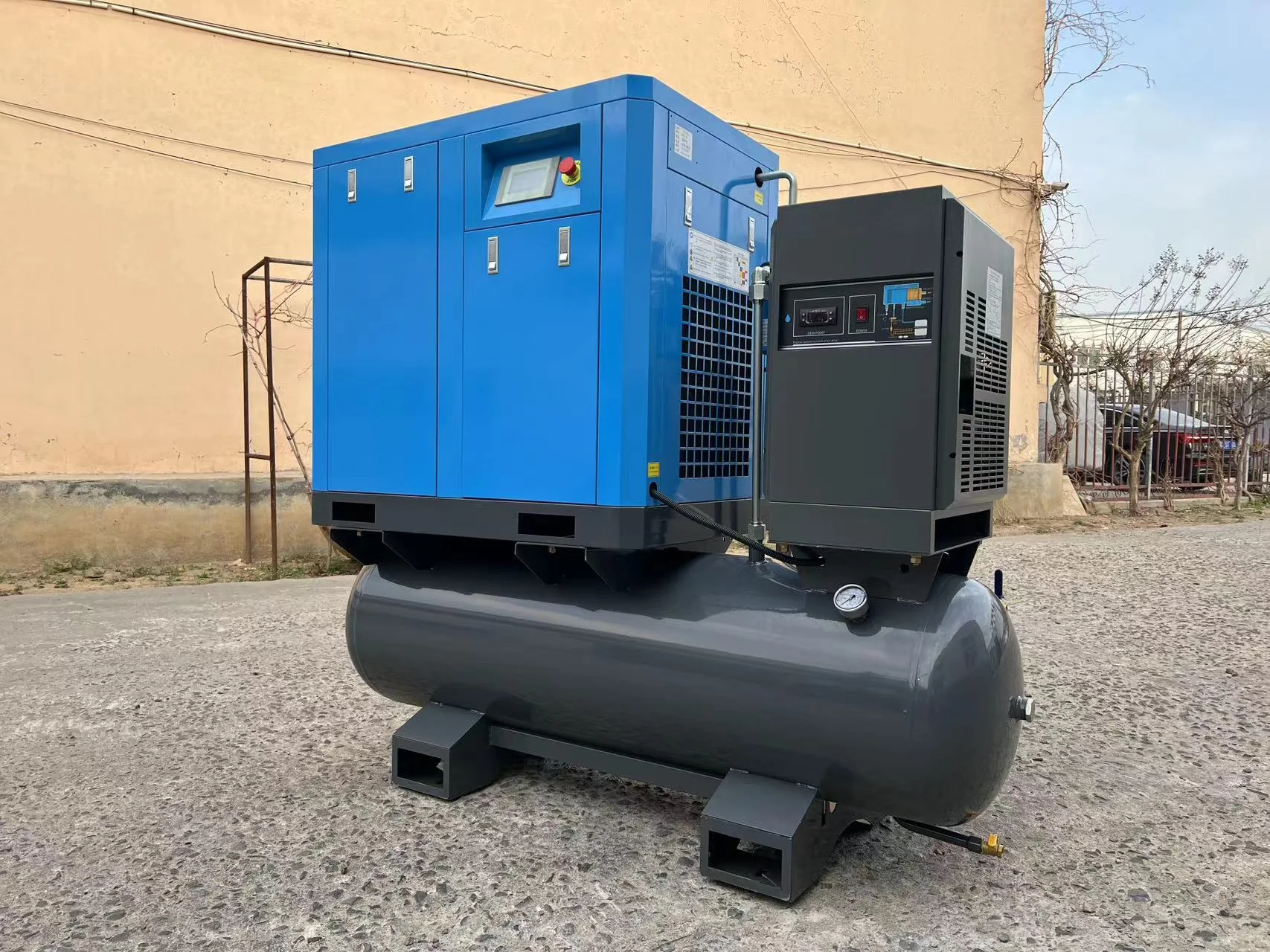 Blue tank-mounted air compressor and separate dryer cabinet outdoors