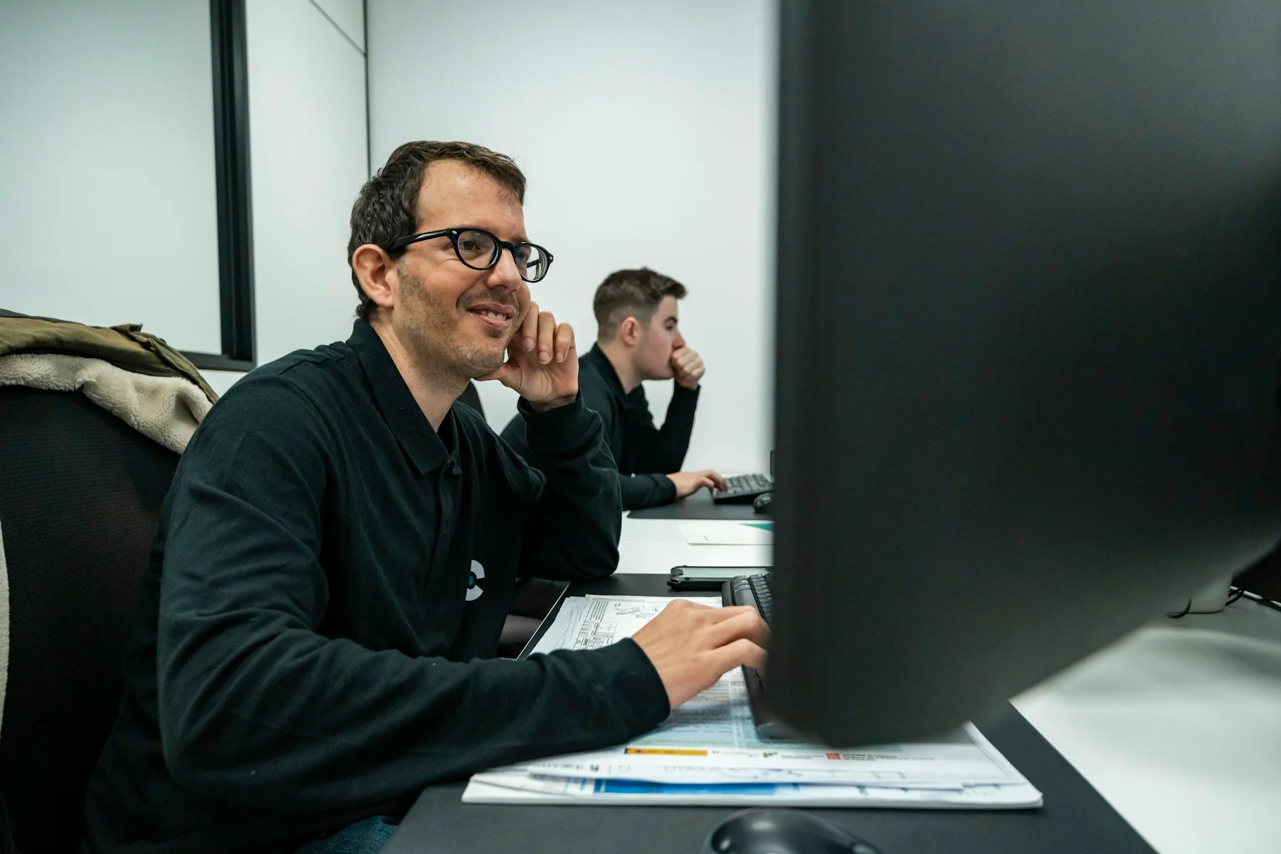 Staff working at technical office computers; reference