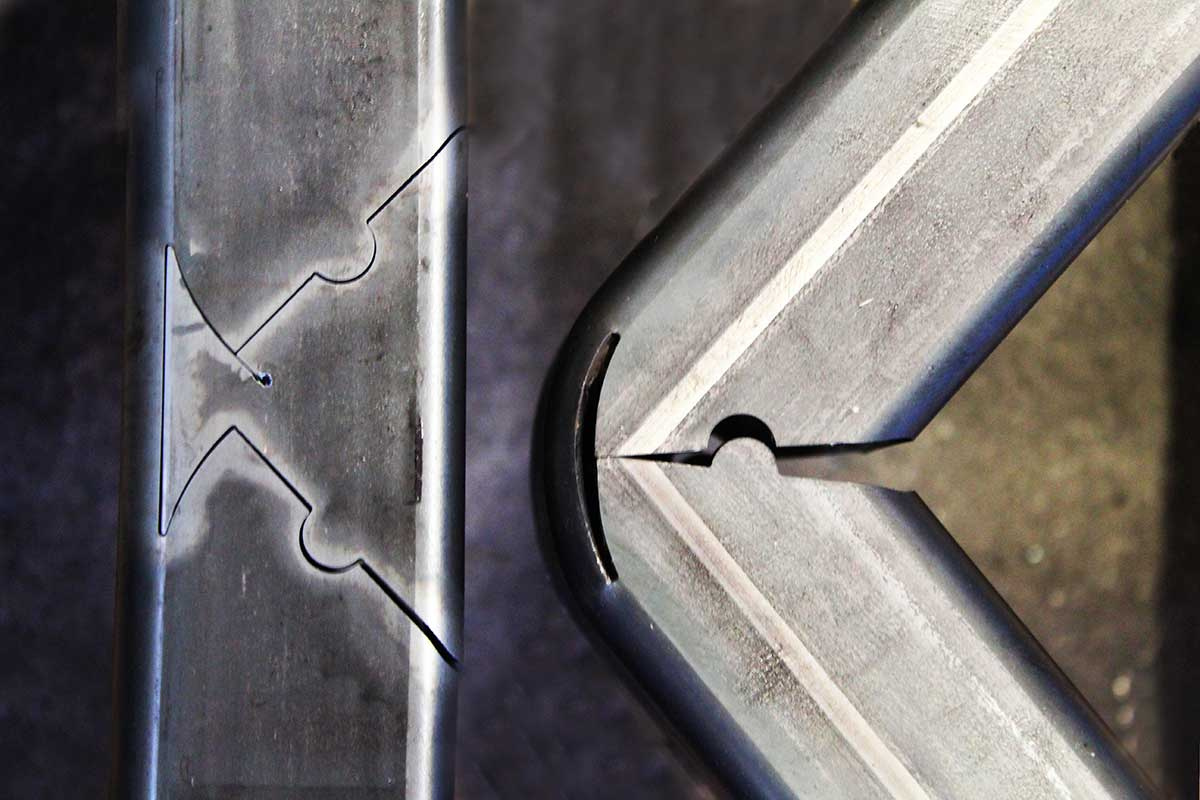 Third-party square-tube sample showing laser-cut relief geometry before and after forming a corner