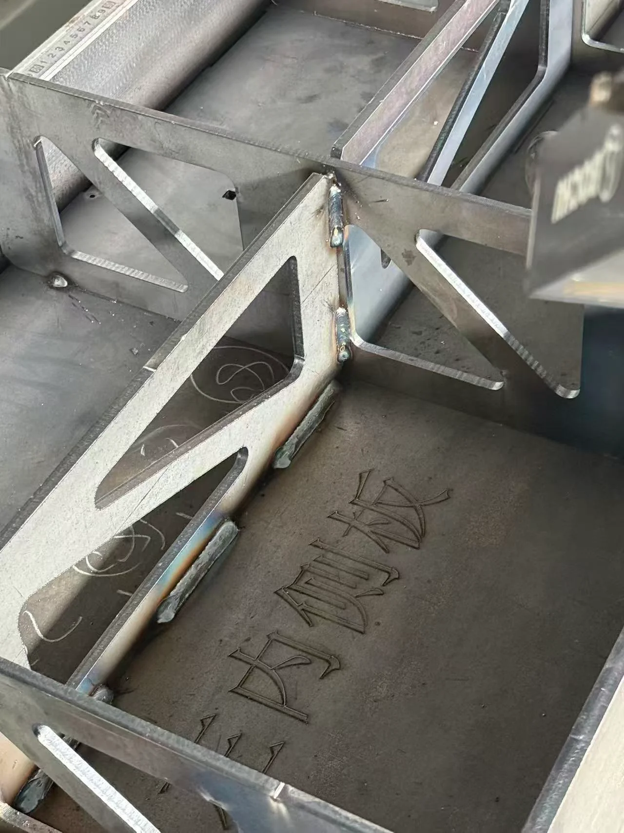 Steel assembly with triangular stiffeners and visible weld joints.